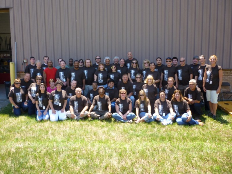 A group of people in black shirts and white jeans.