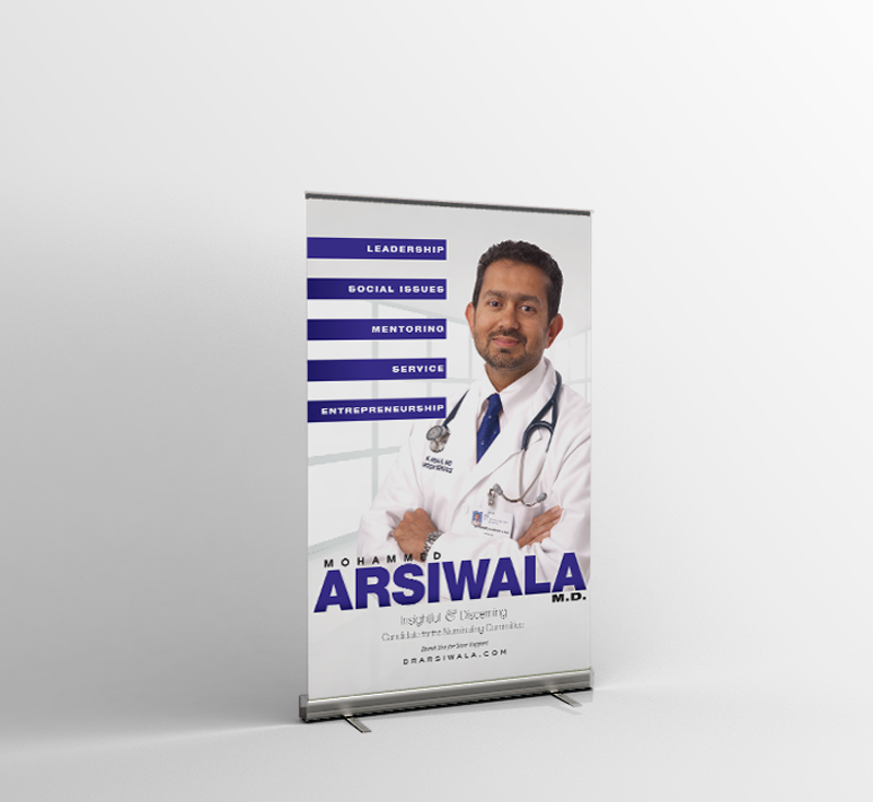 A doctor standing in front of a roll up banner.